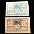 Two vintage German banknotes notgelds with 'Heller' and numbers printed on them.