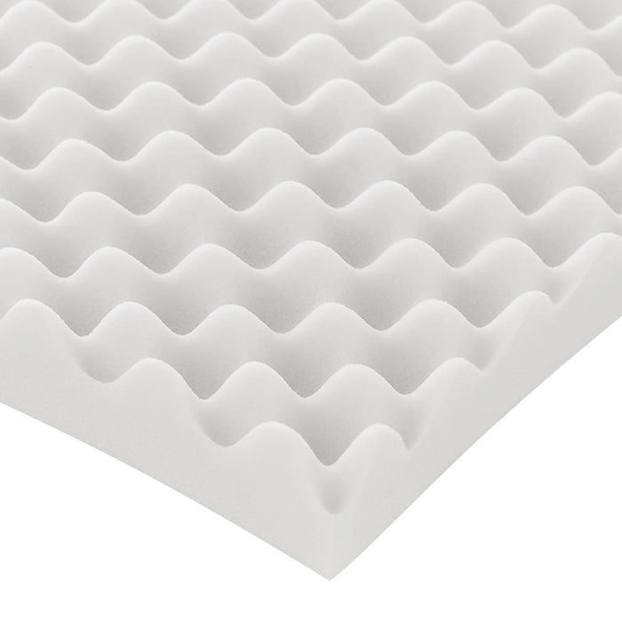 Close-up of white egg-crate foam pad corner on a white background