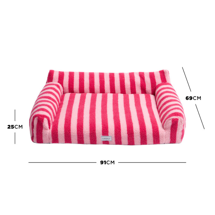 Pink striped pet bed on white background with arrows and labels showing height 25 cm, width 91 cm, depth 69 cm