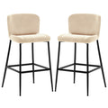 The Bernie High Back Velvet Bar Stool Set of 2 in Oatmeal features beige upholstered seats with low backrests, supported by matte-black metal legs and integrated footrests, offering modern elegance and comfort.