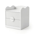 White modern nightstand with wavy top edge, grooved drawer fronts, and central circular handle