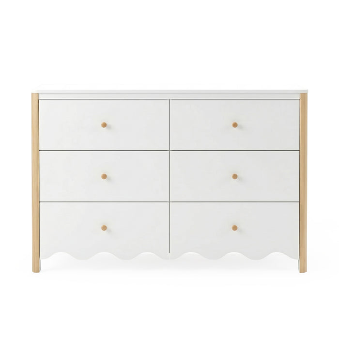 Front view of white six-drawer dresser with scalloped edge and wood accents on white background