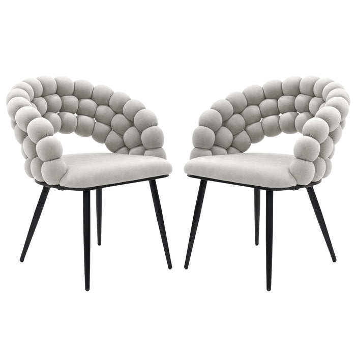 Claudine Velvet Curved Dining Chair Set of 2 in Warm Grey features light-gray upholstered seats with distinctive rounded bubble backrests on slim black metal legs, offering modern elegance and comfort.