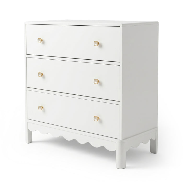 White three-drawer dresser with gold flower knobs on white background
