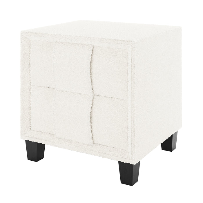 Crossandra Boucle Bedside Table in Cream White, featuring off-white boucle upholstery, four-panel tufted design, and short tapered black wooden legs, offering a chic and functional addition to bedroom decor.