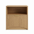 Modern light wood side table with open compartment and textured lower cabinet door on white background.