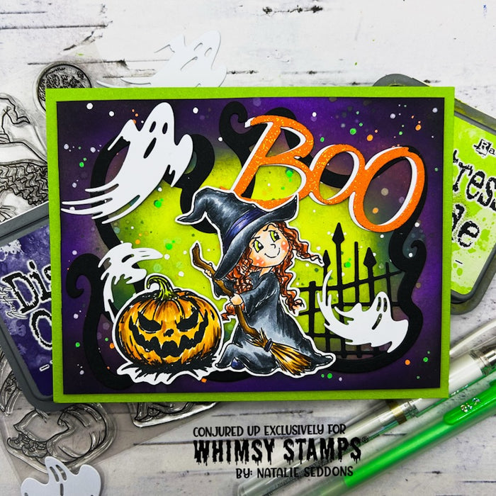 A Halloween handmade greeting card featuring a witch, pumpkin, ghosts, and the word 'BOO' in orange.