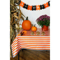 freckled sage stripe orange oilcloth tablecloth with black gingham trim decorated for halloween