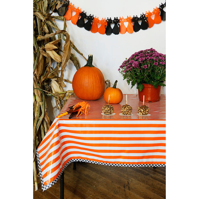 freckled sage stripe orange oilcloth tablecloth with black gingham trim decorated for halloween
