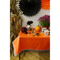 freckled sage solid orange oilcloth tablecloth with black gingham trim decorated for halloween