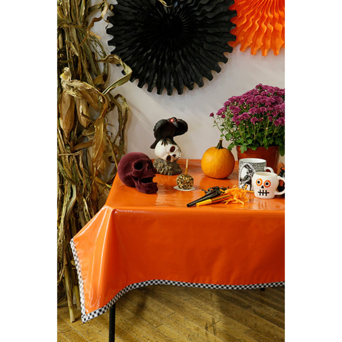 freckled sage solid orange oilcloth tablecloth with black gingham trim decorated for halloween