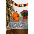 freckled sage toile black oilcloth tablecloth with orange gingham trim decorated for halloween