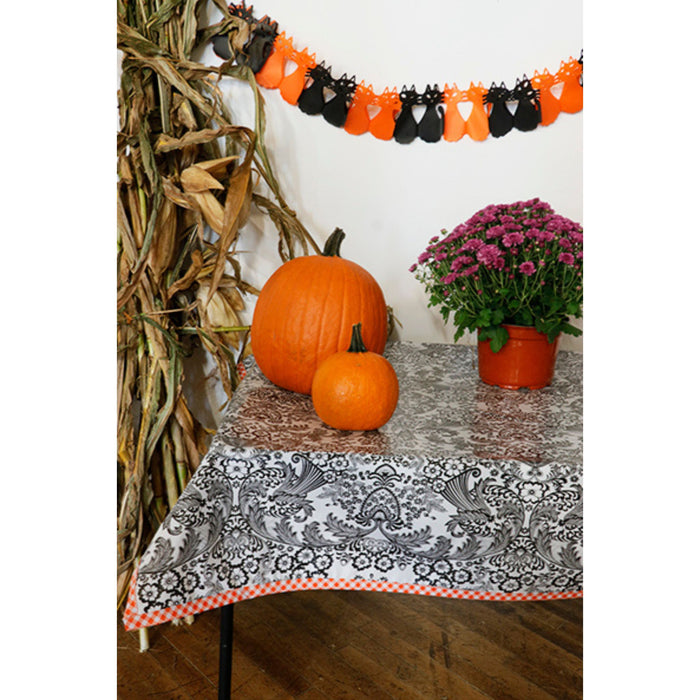 freckled sage toile black oilcloth tablecloth with orange gingham trim decorated for halloween
