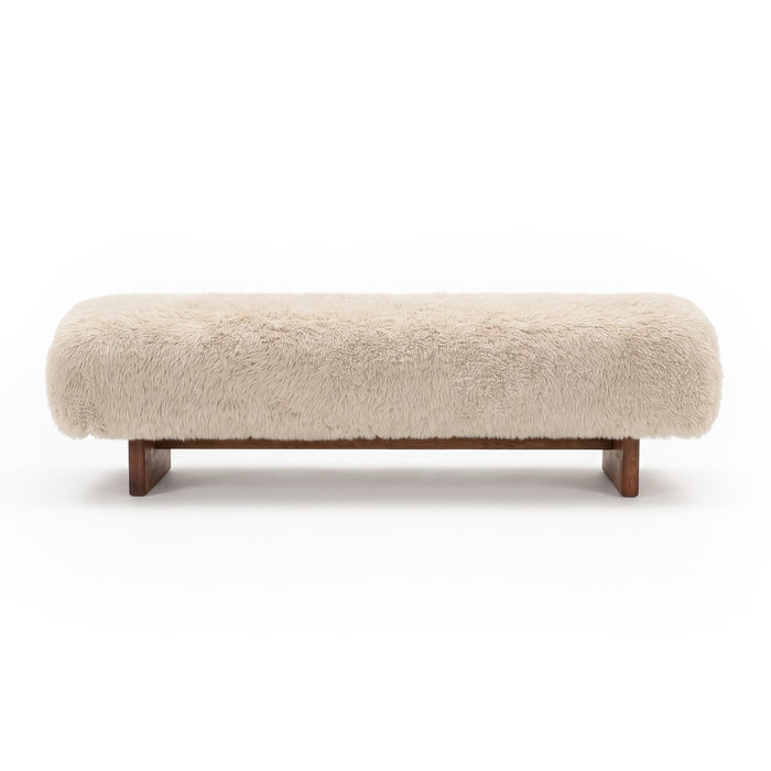 Beige plush upholstered bench with wooden legs on a white background