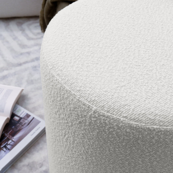 Close-up of the Hiboa Bouclé Ottoman Stool, showcasing its plush texture and curved design, ideal for stylish, multi-use seating.