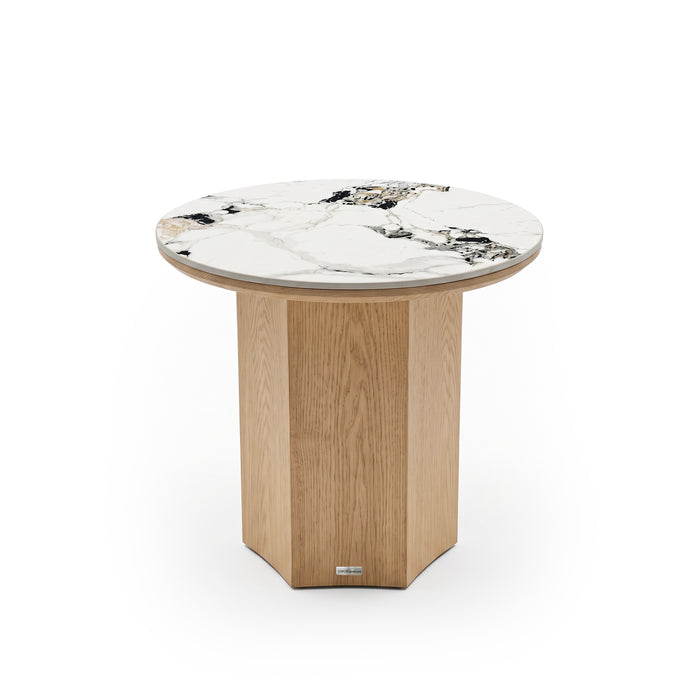 Round accent table with white marble top and faceted light wood base on white background