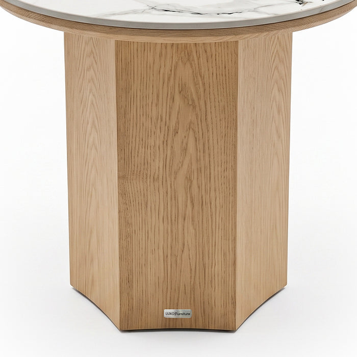 Close-up of the wooden base and lower portion of a round marble-topped table on white background
