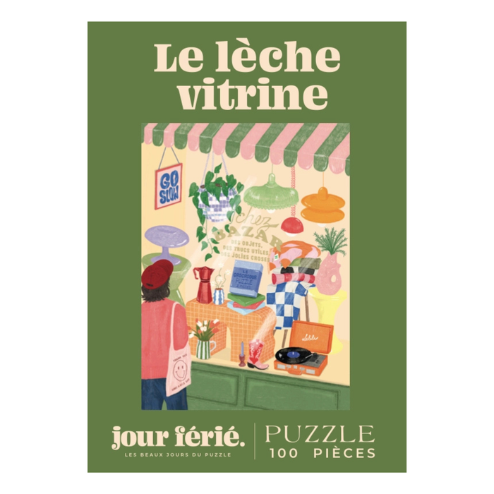 Illustration of people admiring a vibrant shop window; text: Le Lèche Vitrine, Jour Férié. Features a 100-piece jigsaw puzzle by Jour Férié, with an elegant ribbon cut design, made in France.