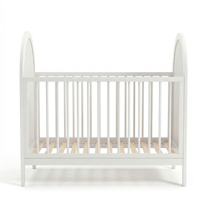Symmetrical front view of white crib with arched sides and evenly spaced slats