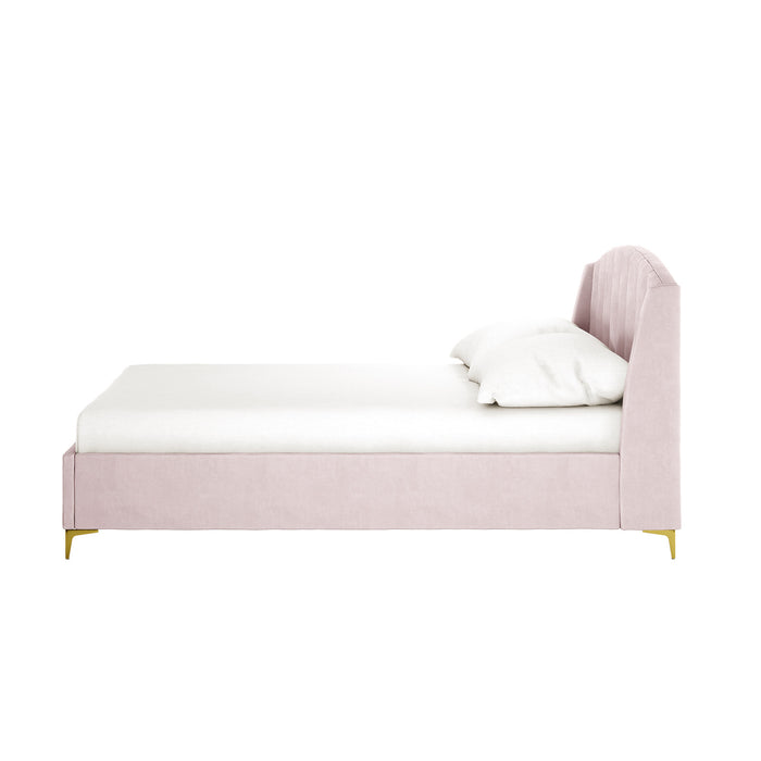 Lyra Velvet Bed Frame with Winged Headboard - Soft Pink Double, featuring blush velvet upholstery, gently curved channel-tufted headboard, white mattress, pillow, and slender gold-tone legs.