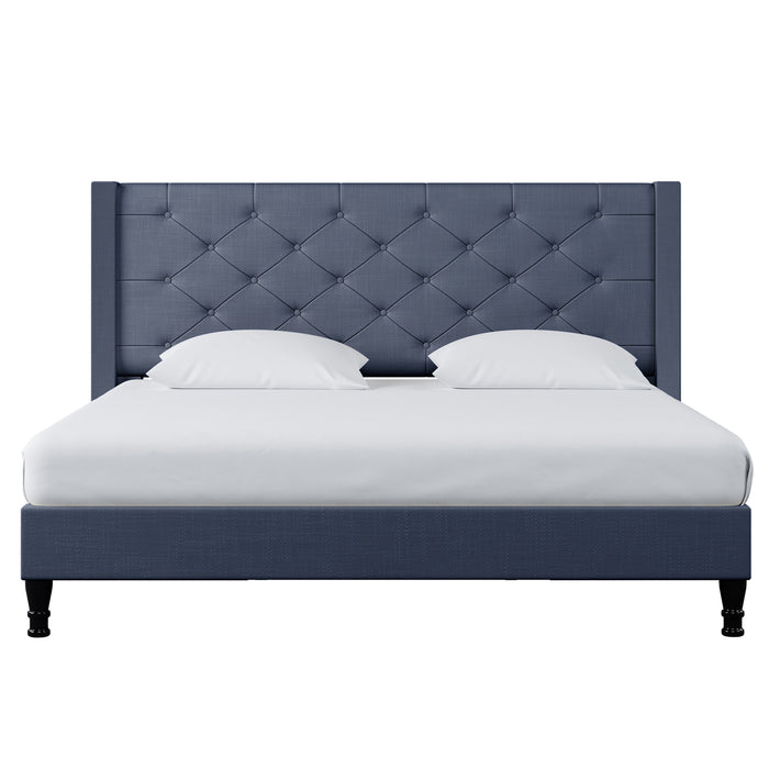 Maggie King Winged Fabric Bed Frame – Dark Blue with a tall, button-tufted headboard, white bedding, and dark wood legs, offering a blend of old-world charm and contemporary style.