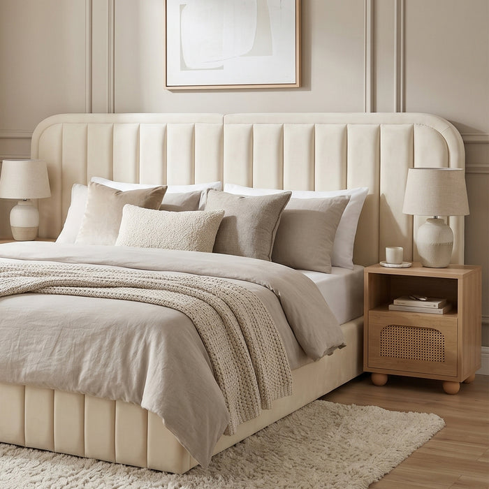 Modern upholstered bed with cream headboard in a styled bedroom