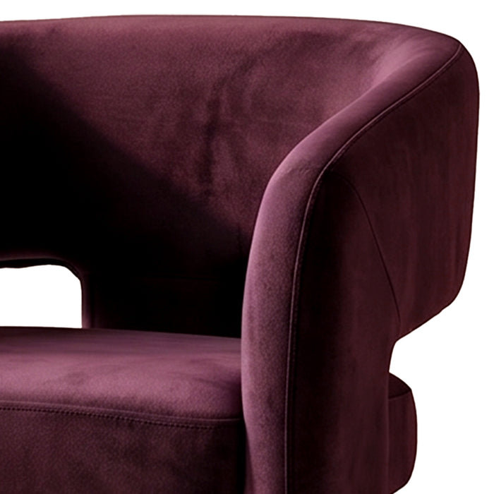 Close-up partial view of plum velvet chair on white background
