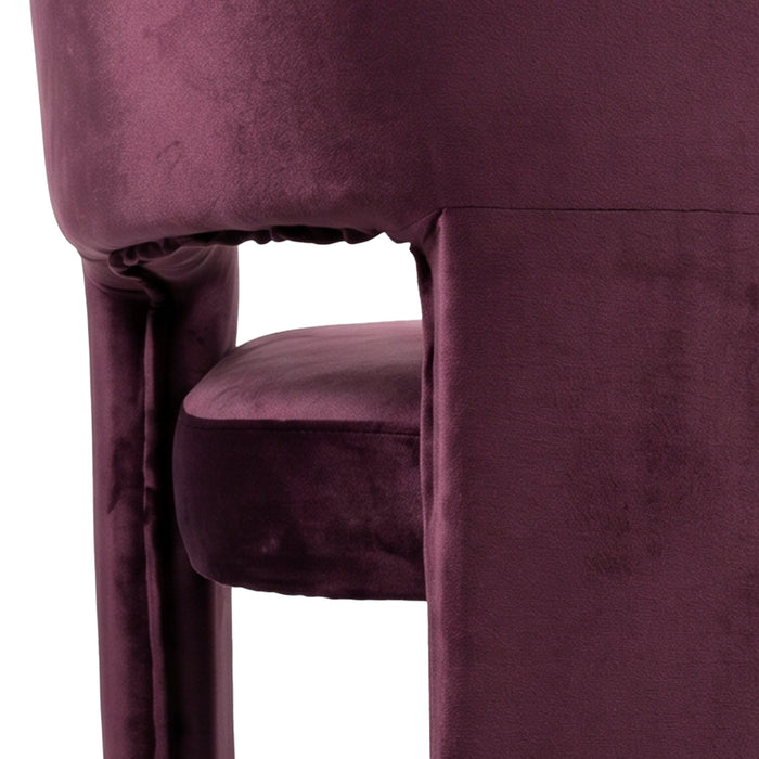 Close-up of burgundy velvet chair side and seat on white background