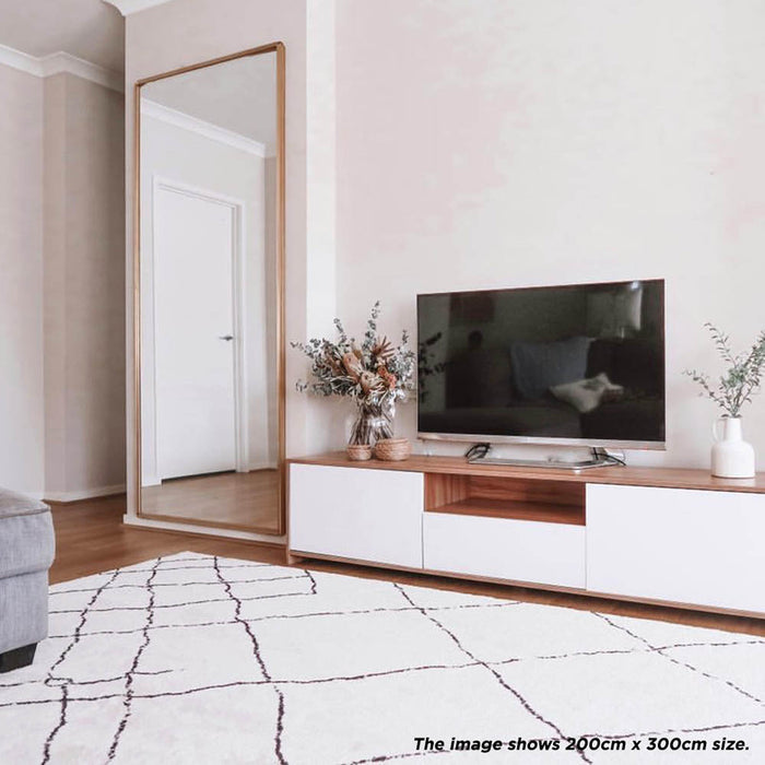 Melody Black & White Modern Rug 160x230cm displayed, featuring abstract black lines on an ivory base, ideal for enhancing dining or living areas with its Scandinavian-inspired design.