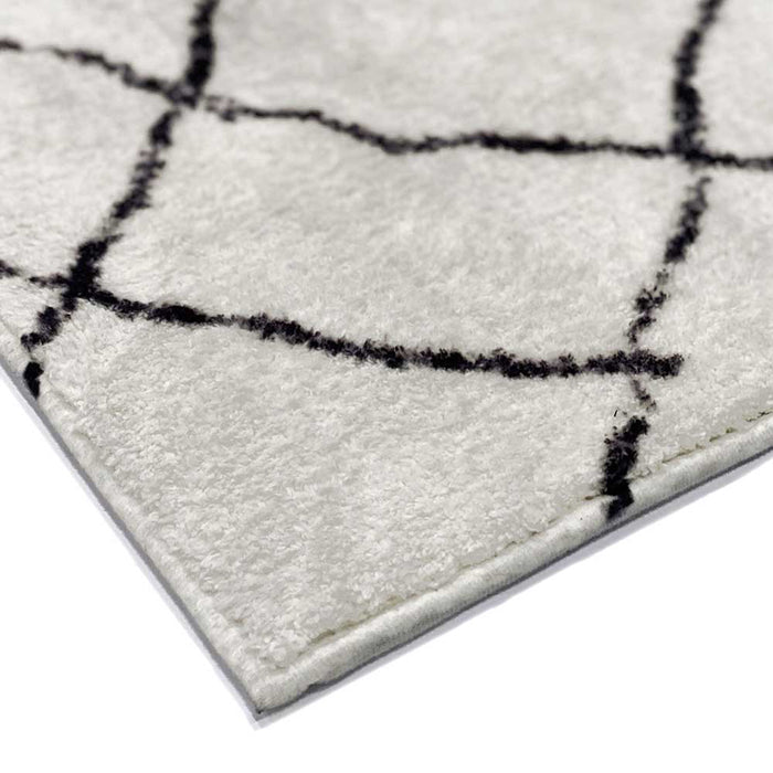 Close-up of the Melody Black & White Modern Rug 160x230cm, displaying black abstract lines on ivory, showcasing its Scandinavian-inspired design and soft texture, ideal for high-traffic areas.