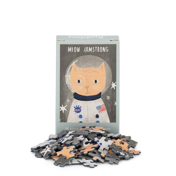 The Meow Armstrong | 99 Piece Mini Jigsaw Puzzle by Happily Jigsaw Puzzles features a cat in an astronaut suit on the box, playfully nodding to Neil Armstrong with its fun design and mini puzzle pieces.