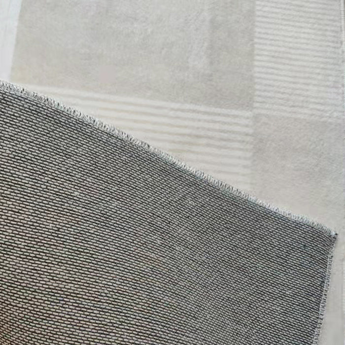 Close-up of Nicho 160x230cm Polyester Tufted Modern Abstract Indoor Rug, showcasing its tightly woven texture over a subtly checkered carpet, highlighting the rug's intricate modern design.