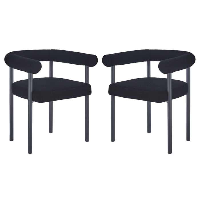 Ohio Curved Boucle Dining Chair Set of 2 in Black features low, rounded backrests and tubular armrests upholstered in black bouclé fabric, supported by sleek black metal legs for a modern look.