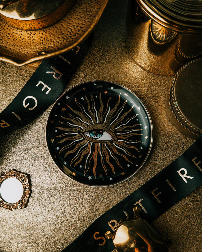 Decorative coaster with eye design on a textured surface with 'S.T.E.A.M' branding.