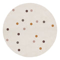 Roya 160x160cm Round Polka Dot Kids Indoor Rug features a cream surface adorned with playful, muted polka dots in browns, pinks, and ochres, enhancing any child's space with charm and warmth.