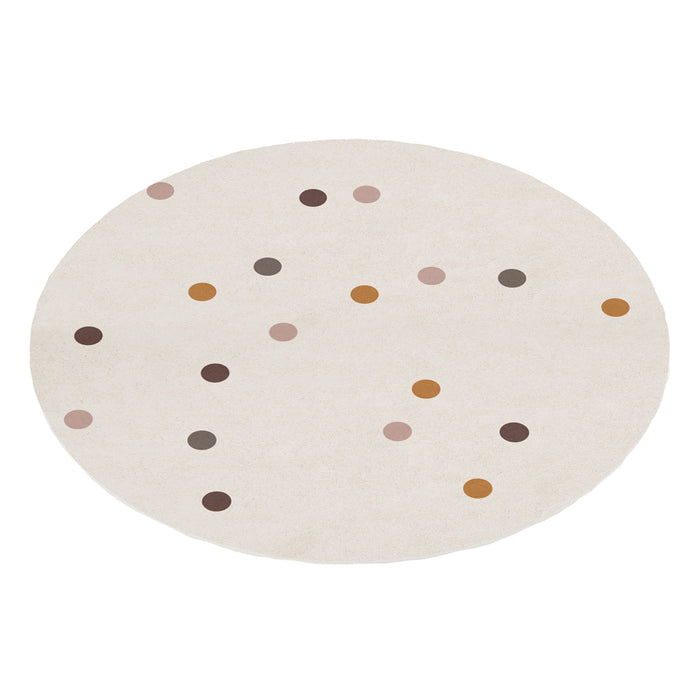 A round, cream-colored kids rug featuring a scattered pattern of multi-colored polka dots in muted tones of brown, ochre, and dusty pink.