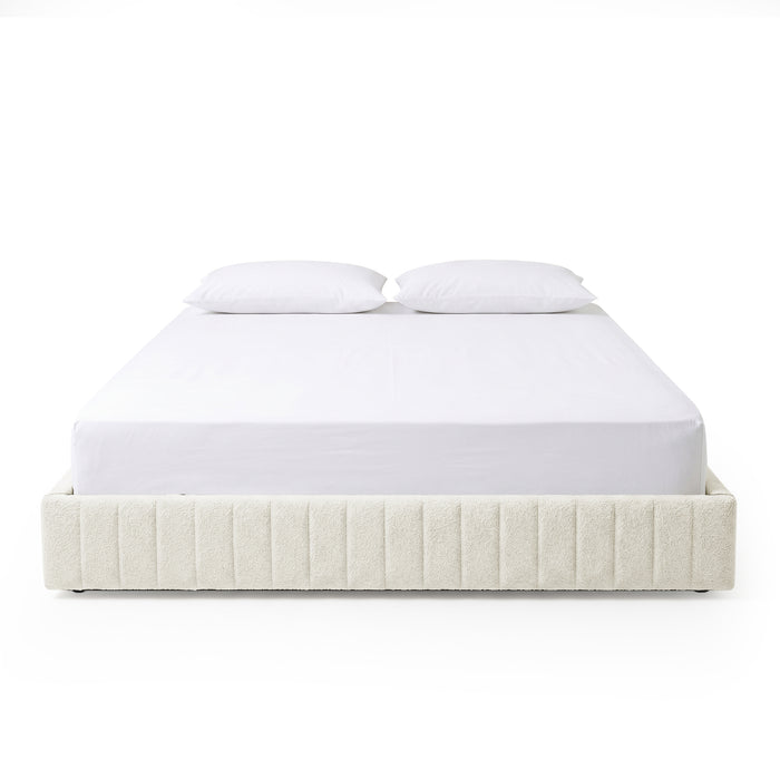 Front-facing upholstered bed with white bedding on white background