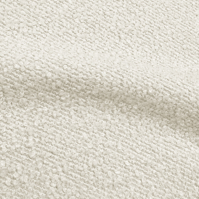 Close-up of boucle cream white fabric texture showing woven detail