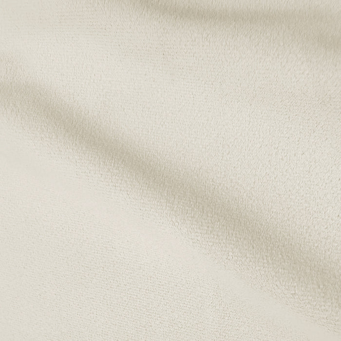 Close-up of light warm beige textured upholstery fabric showing soft directional pile