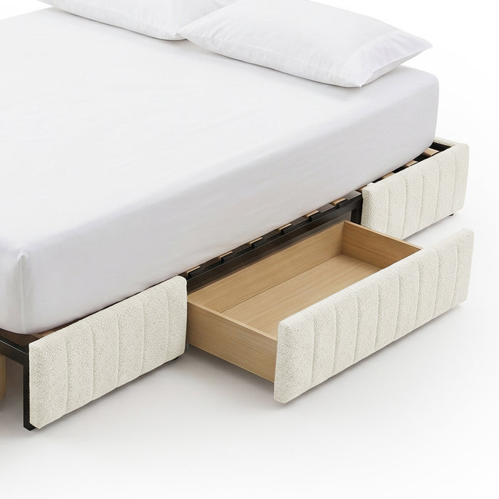 Modern bed frame with one open under-bed storage drawer against a white background