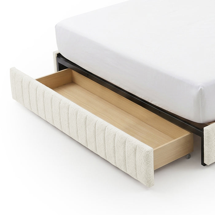 Close-up view of extended storage drawer from upholstered bed on white background