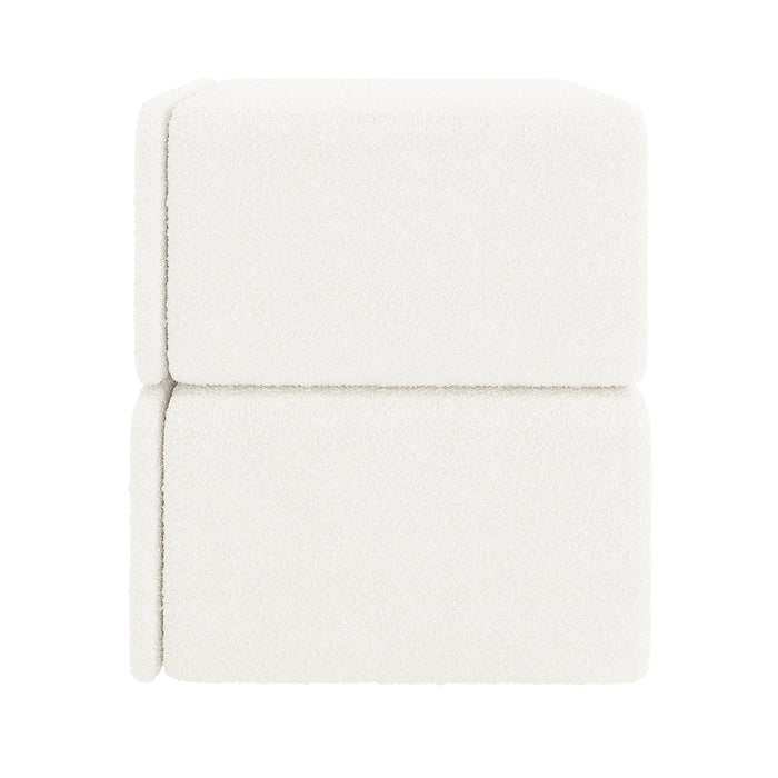 Tyla Boucle Bedside Table in Cream White, featuring cube-shaped upholstery blocks stacked, covered in soft boucle fabric, suggesting a modular design. This elegant piece offers both functionality and style for bedrooms.