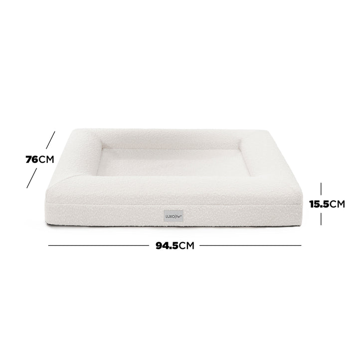Tyro Luxe Medium Orthopedic Pet Bed – Light Beige; close-up of a plush, textured surface with a subtle logo, highlighting its supportive structure and premium fabric designed for pet comfort.