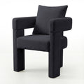 Utah Bouclé Curved 3 Legged Accent Chair in Black with plush bouclé upholstery, squared padded seat, thick tubular armrests
